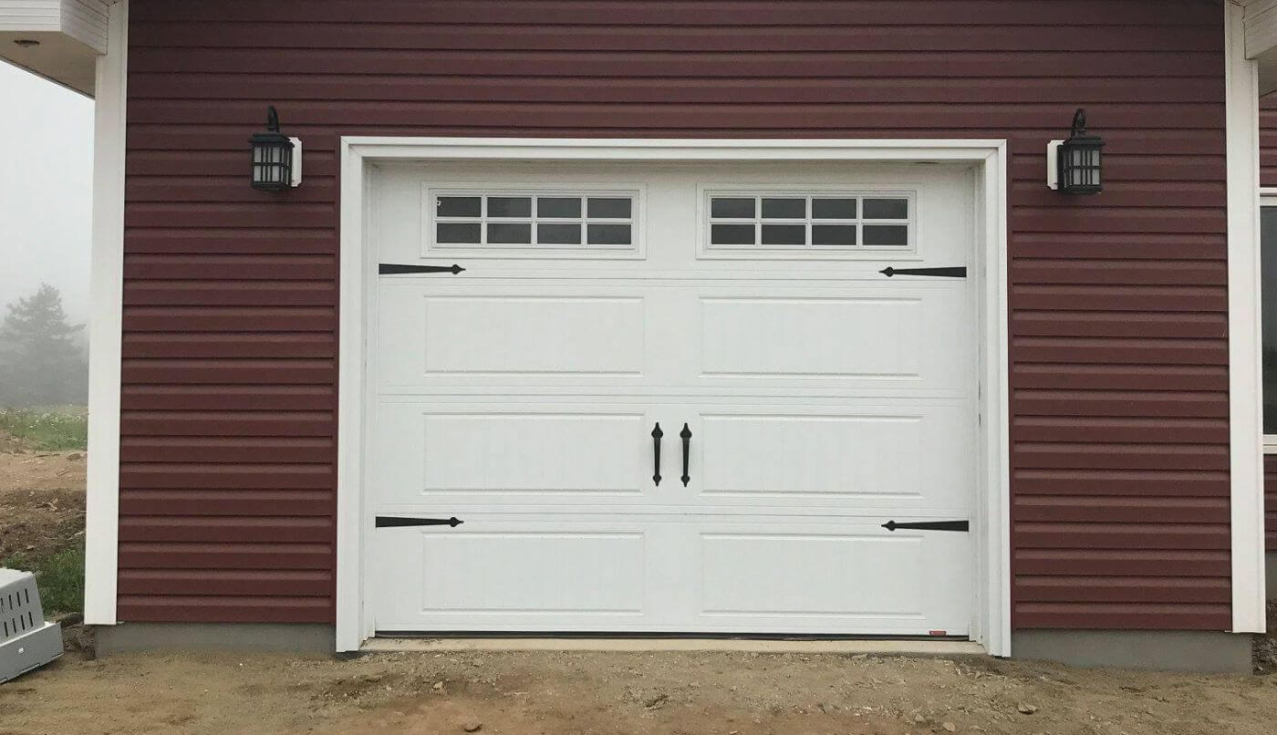 A garage door with two windows, highlighting simplicity and elegance in its appearance.