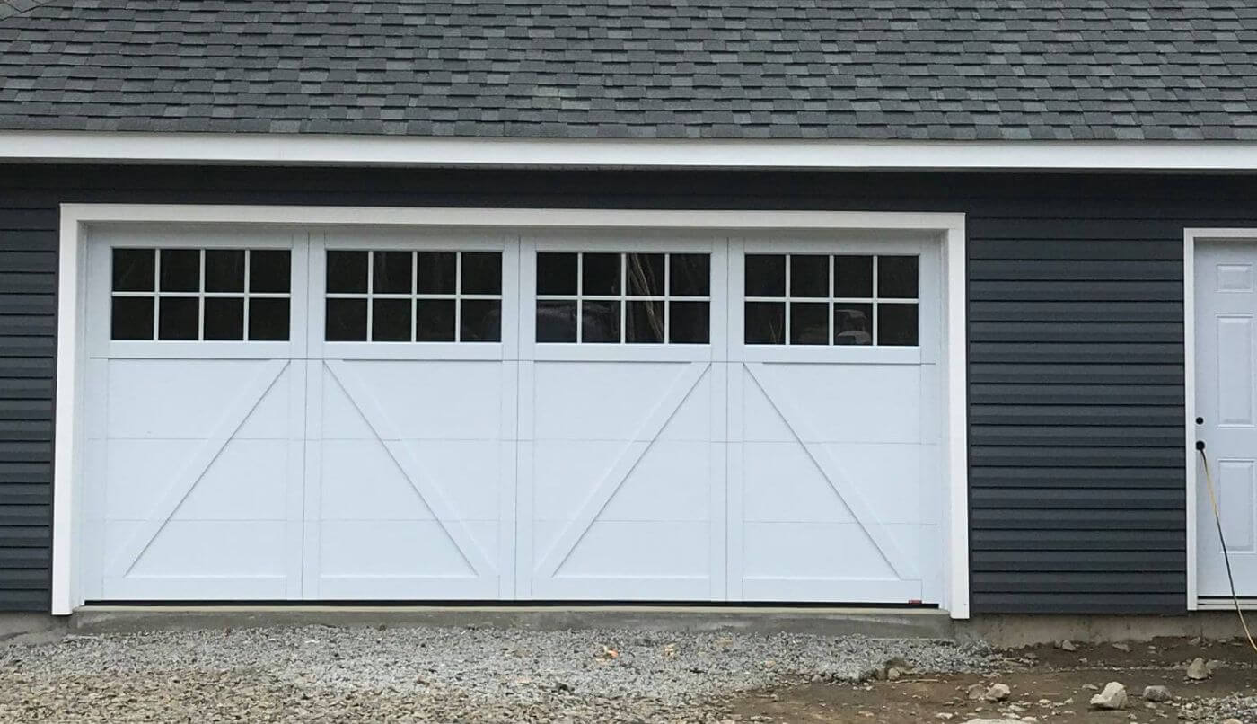 A garage door featuring windows, providing a blend of functionality and aesthetic appeal.